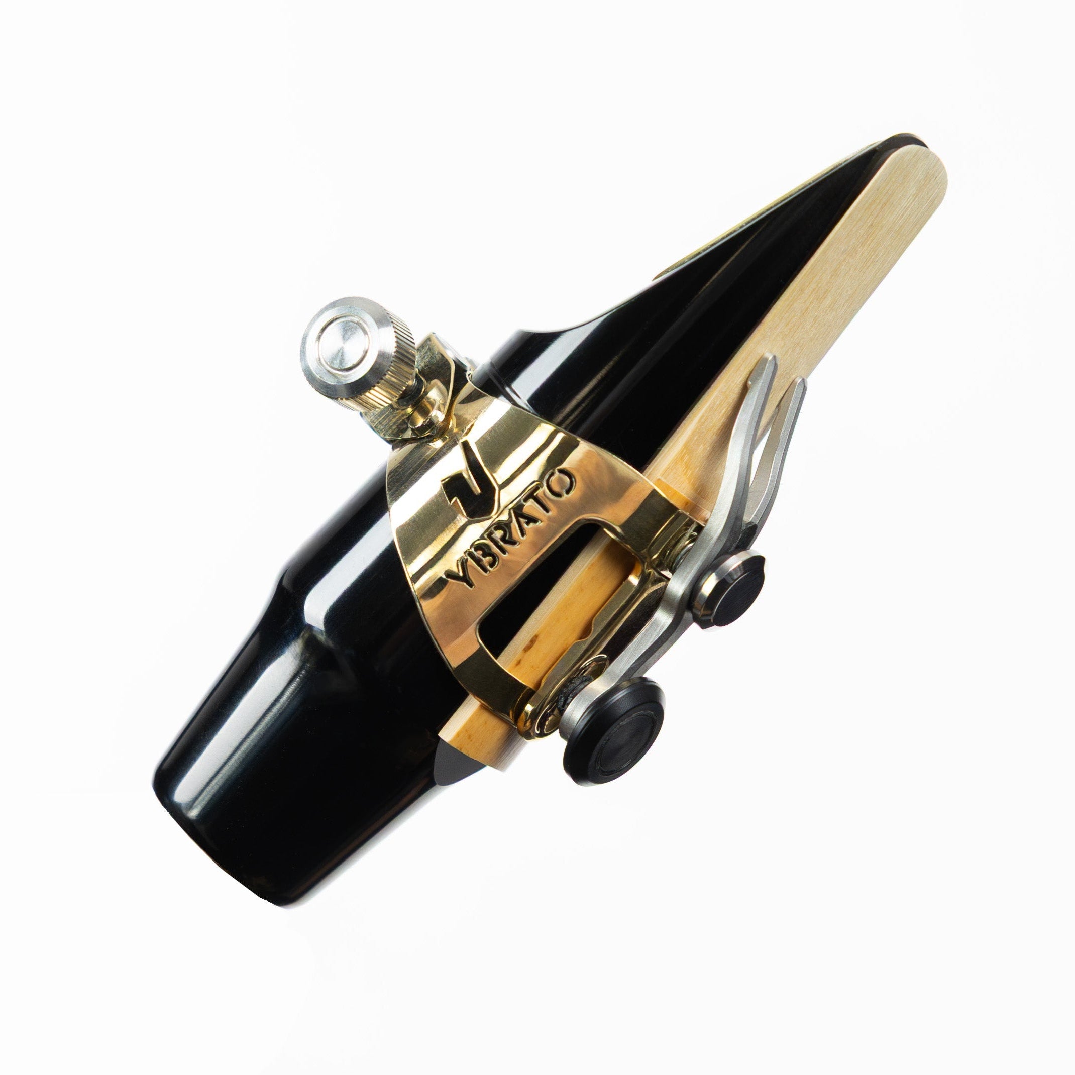 Ybrato SweetSpot Ligature mounted on a black saxophone mouthpiece with reed