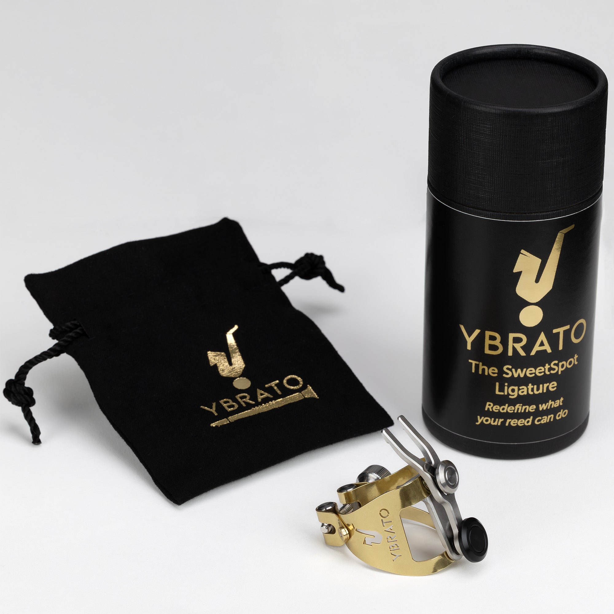 Ybrato SweetSpot Ligature product set, including gold ligature, black pouch, and premium packaging with gold Ybrato logo