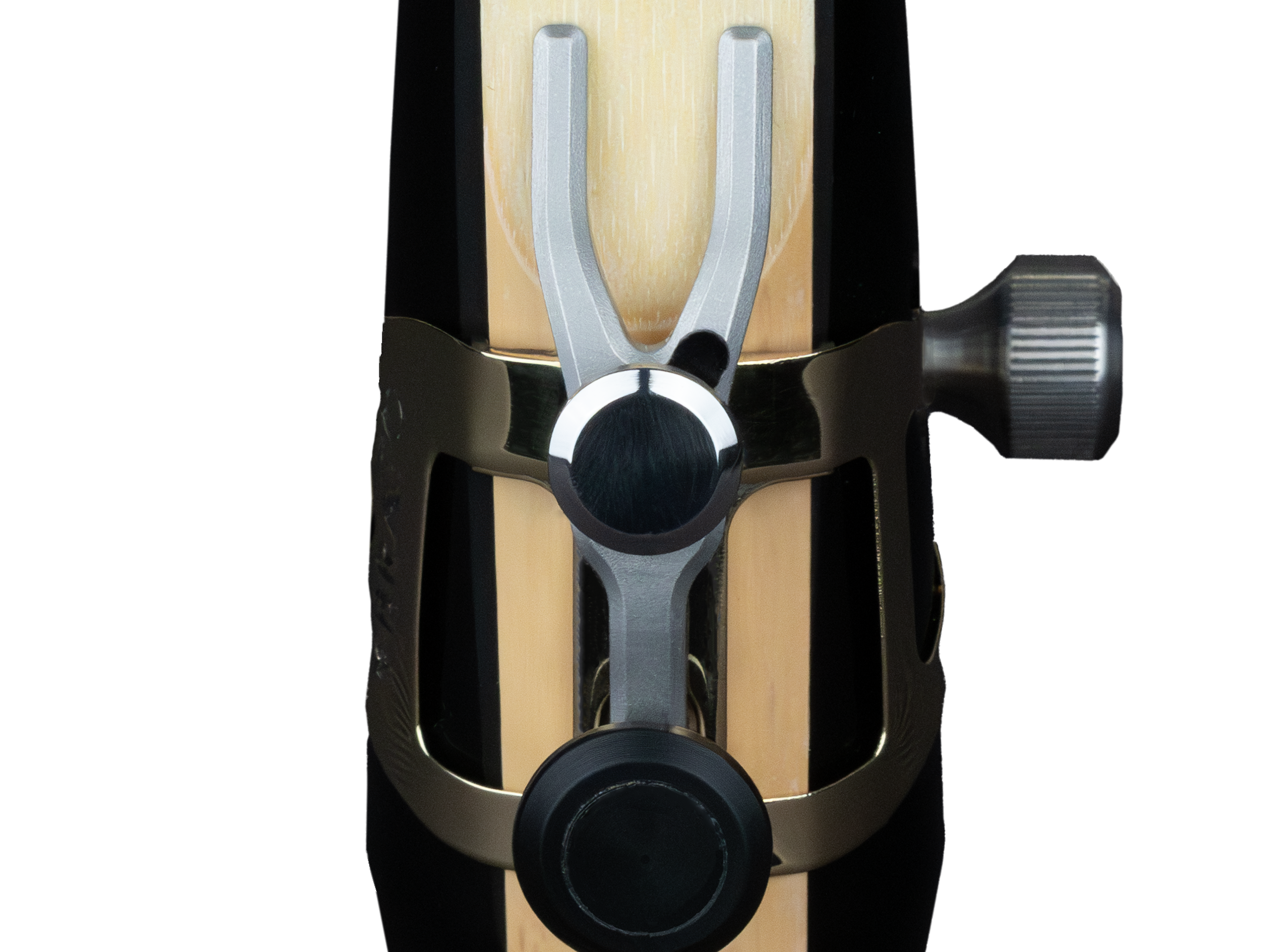 Close-up of the Ybrato SweetSpot Ligature on a saxophone mouthpiece, focusing on the reed tip adjustment mechanism