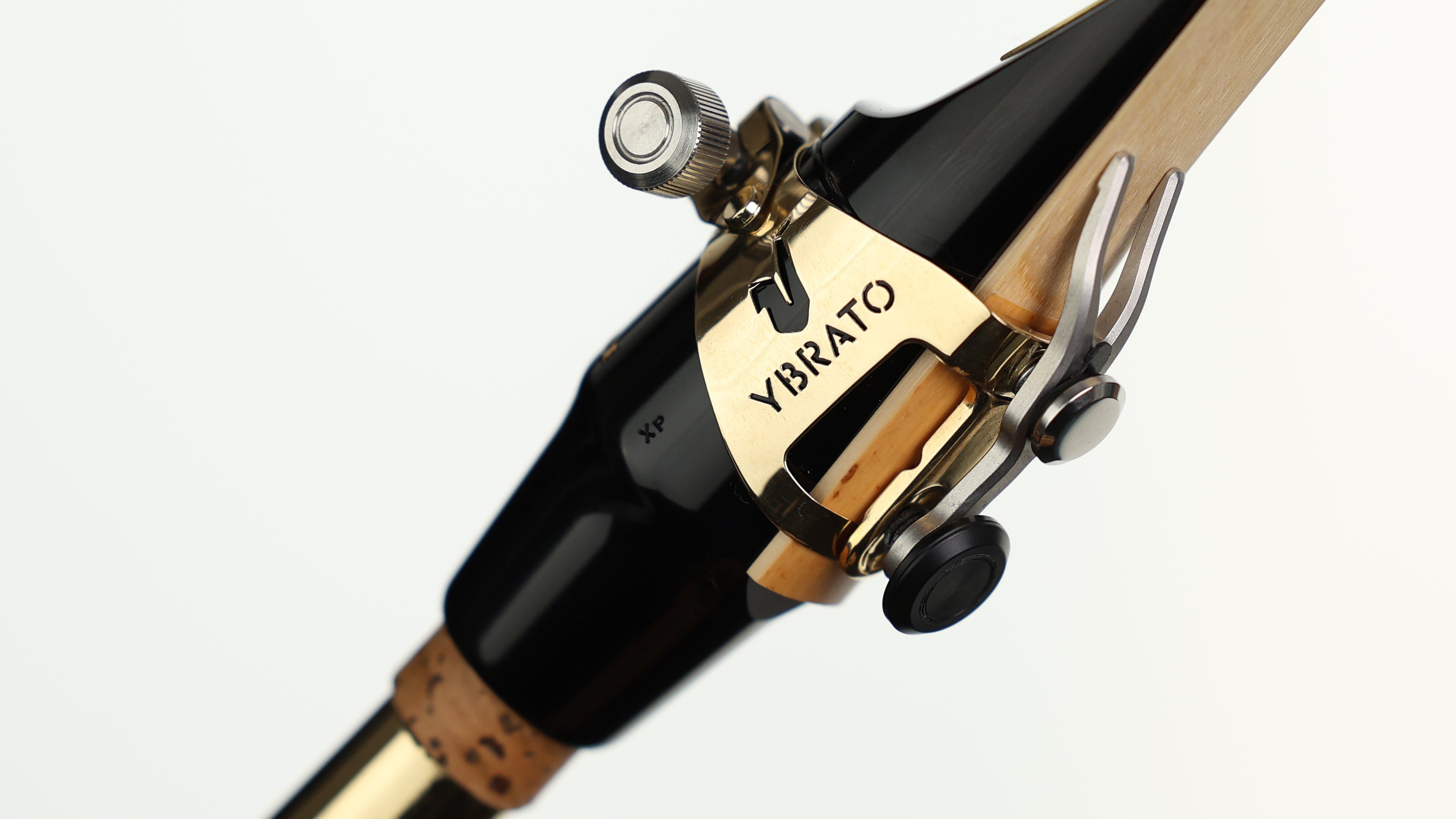 Ybrato SweetSpot Ligature attached to a saxophone mouthpiece on an instrument, highlighting the reed and ligature setup
