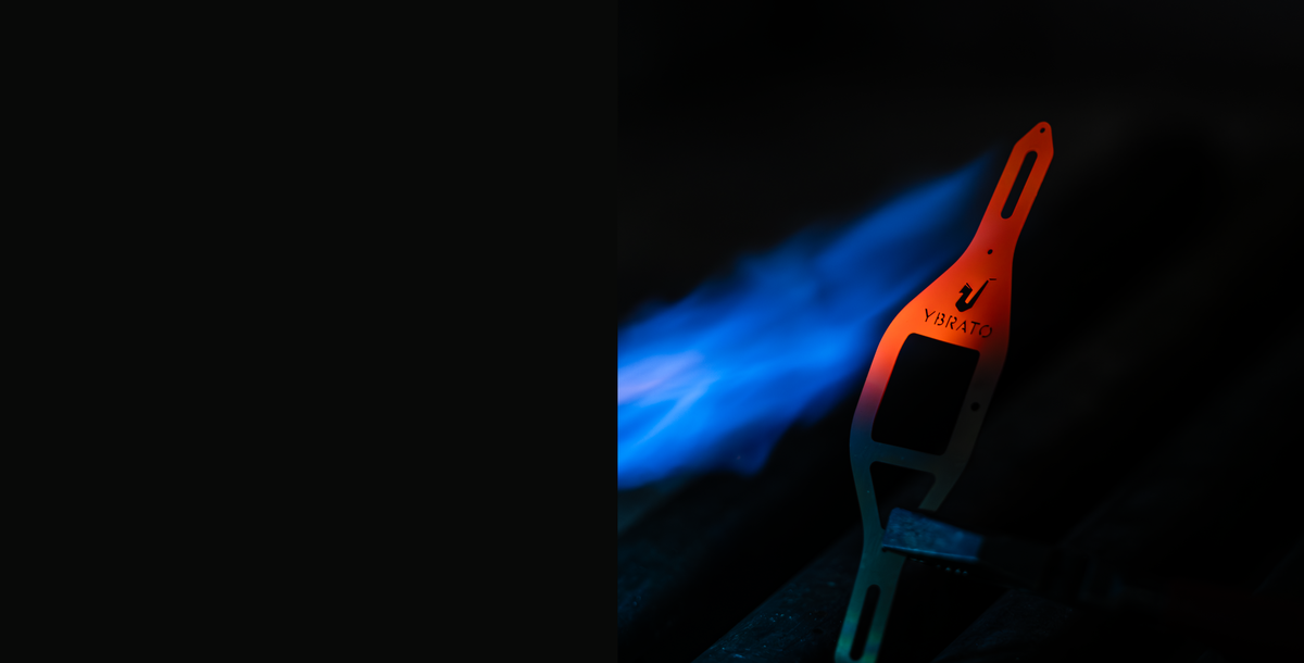 YBRATO SweetSpot Ligature during the manufacturing process, illuminated by blue flame - desktop view